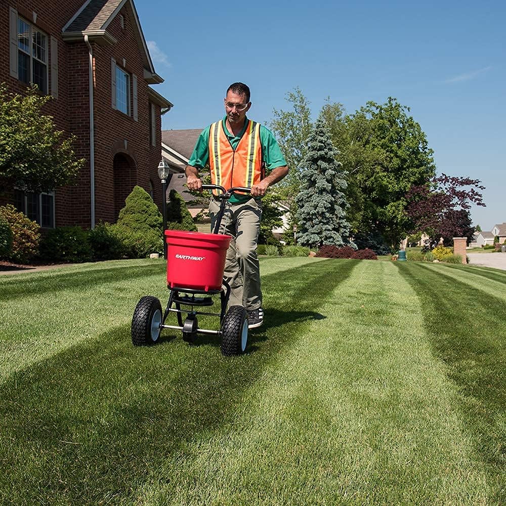 EarthWay 2150 Commercial 50 LB Broadcast Fertilizer Spreader. Heavy-Duty Walk-Behind Push Garden Seeder with Adjustable Drop Rate and Driving Handle. Large 13 inch Pneumatic Stud Tires